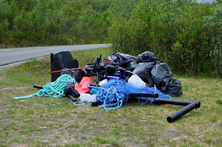 Junk piled on a grassy lawn